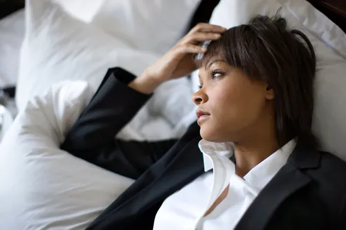 photo of anxious businesswoman on bed