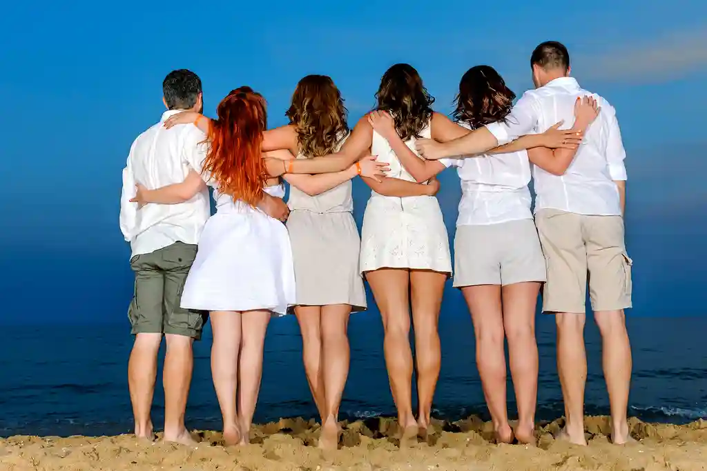 photo of six friends embracing on beach