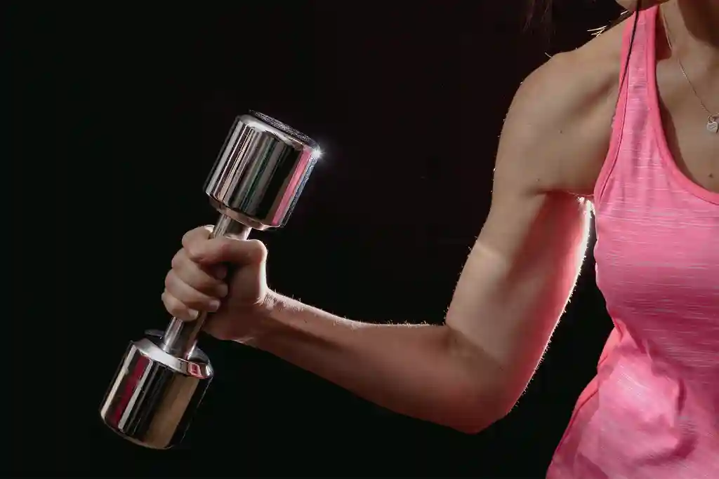 photo of woman exercising with dumbbell
