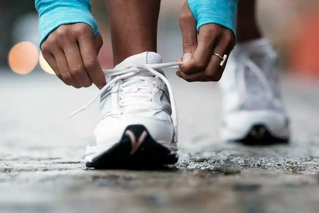 photo of runner tying shoelaces