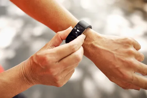 photo of woman checking fitness tracker