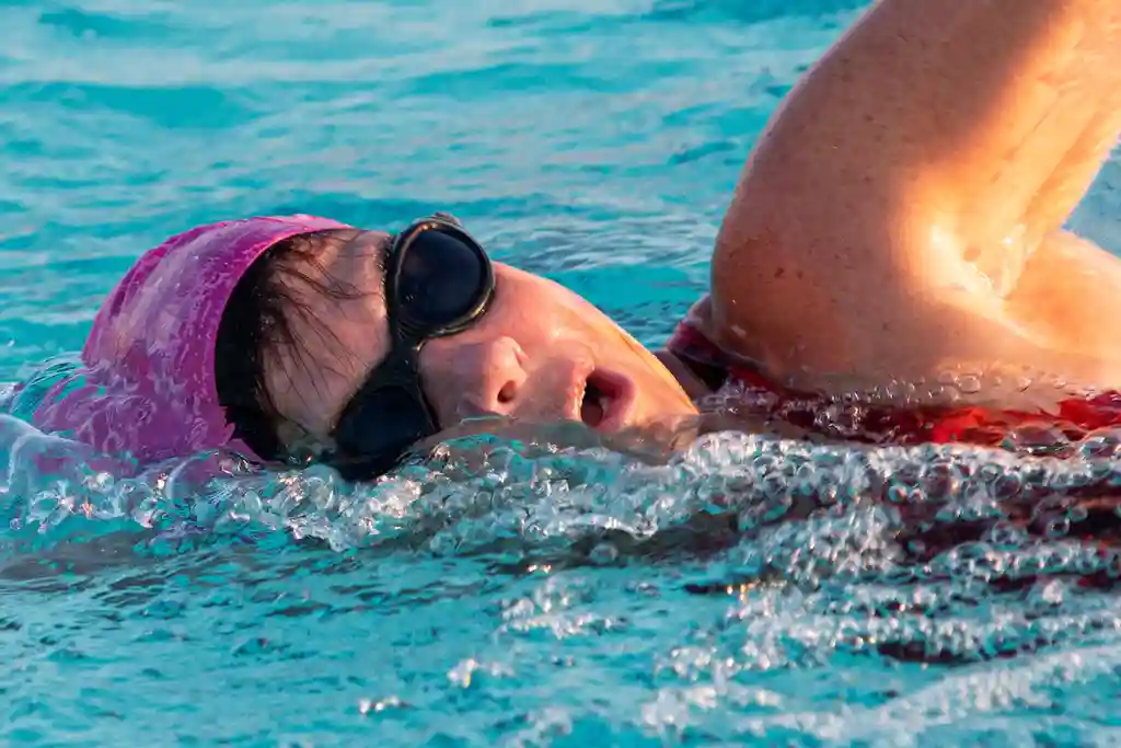 photo of woman swimming laps