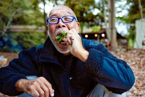 photo of man eating salad outdoors