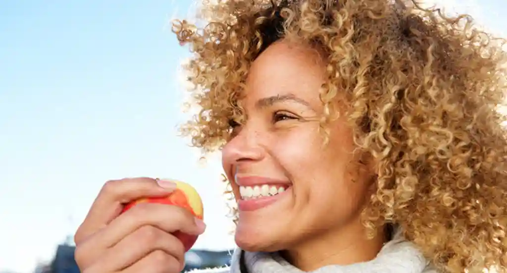 Woman eating apple