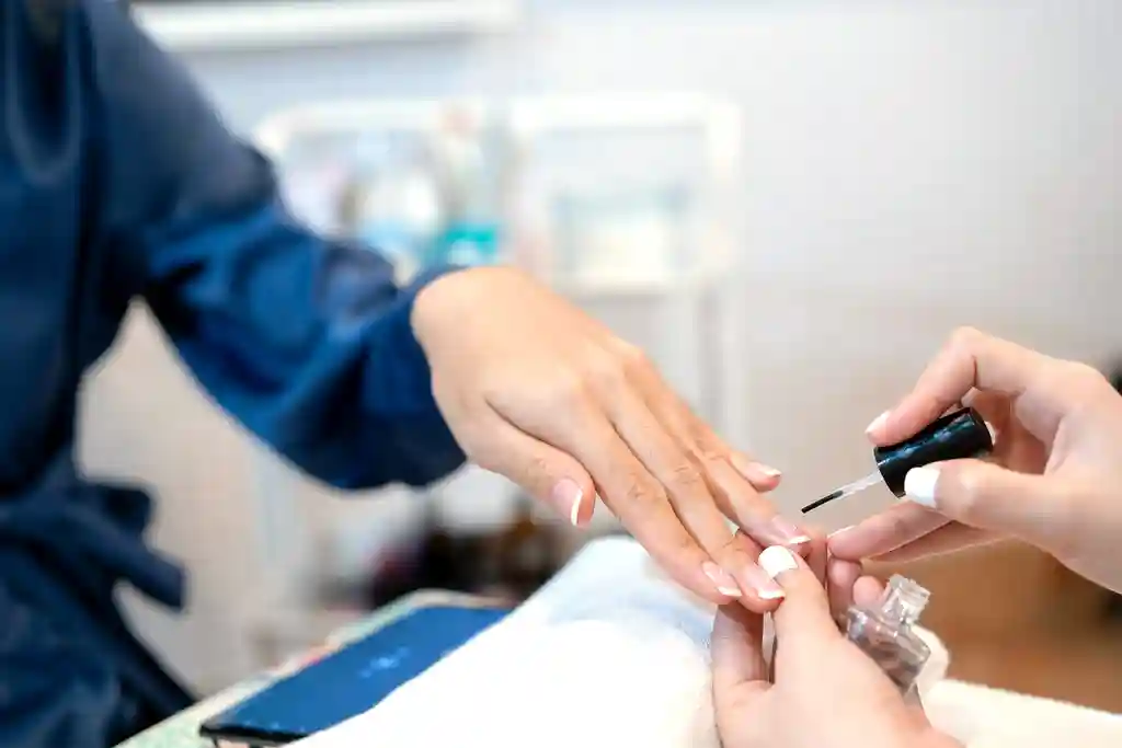 photo of close up of woman having her nails done