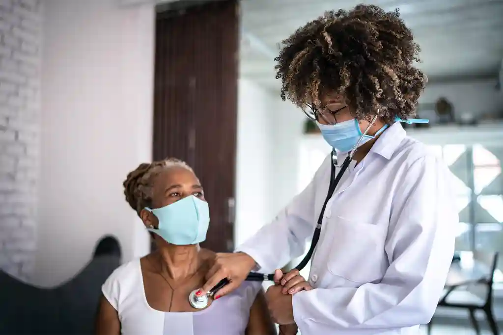photo of doctor using stethoscope on patient 