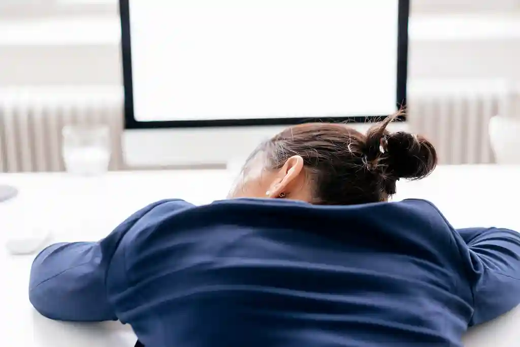 photo of tired businesswoman sleeping on desk