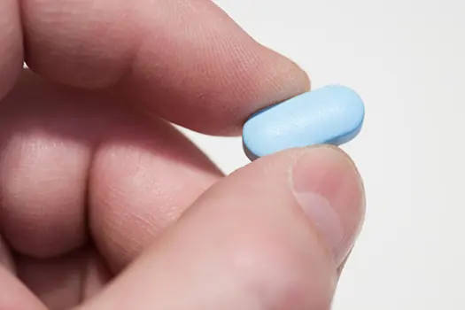 person holding pill