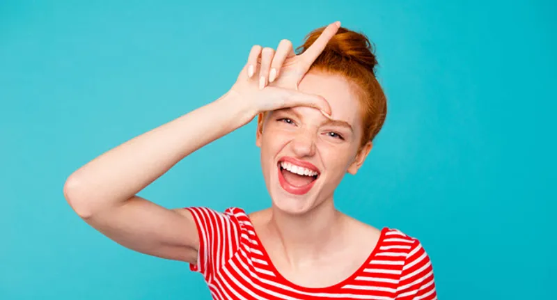 woman making loser sign