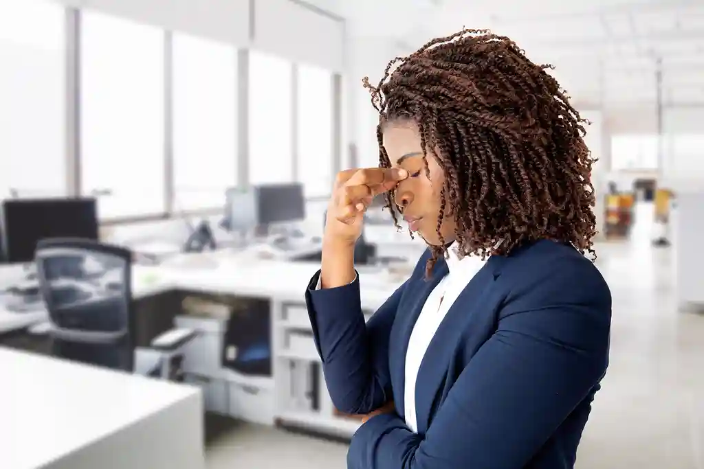 photo ofbusinesswoman with eheadache in office