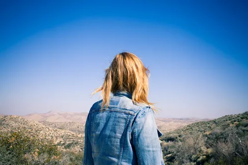 photo of woman looking out at landscape
