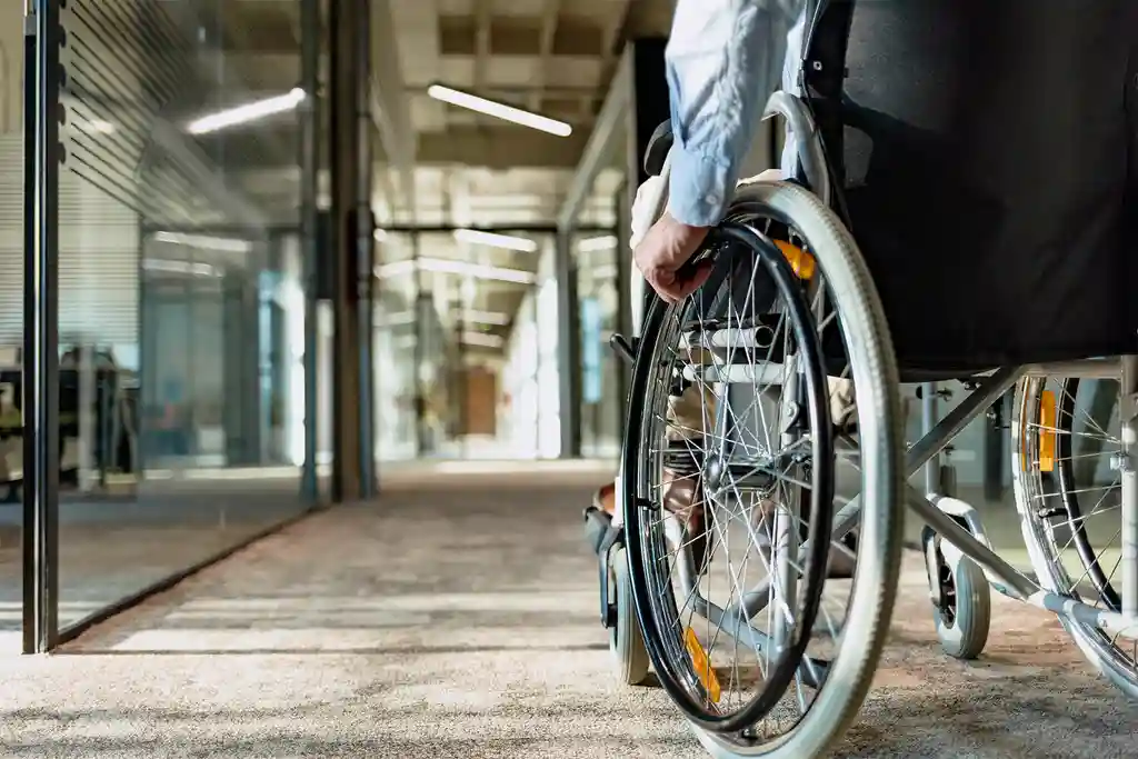 photo of man in a wheelchair in office building