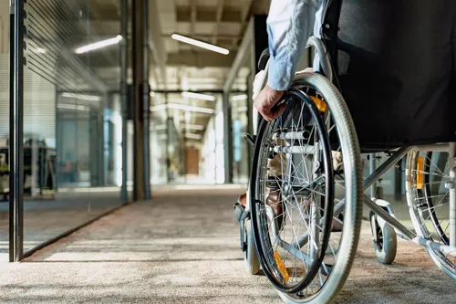 photo of man in a wheelchair in office building