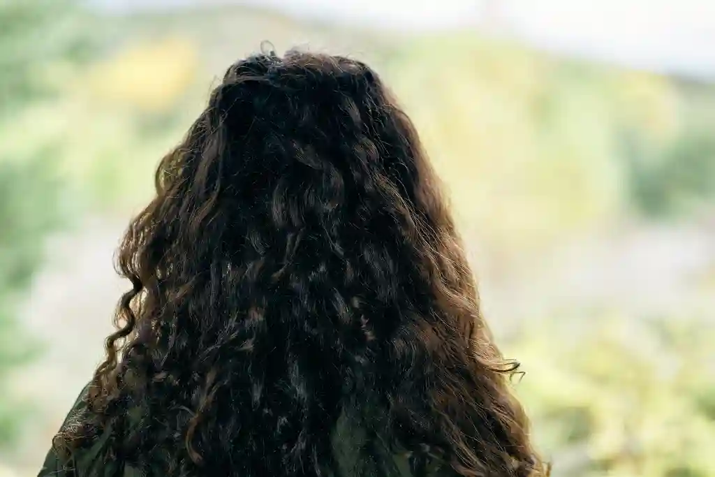 photo of woman w long curly hair viewing scenery