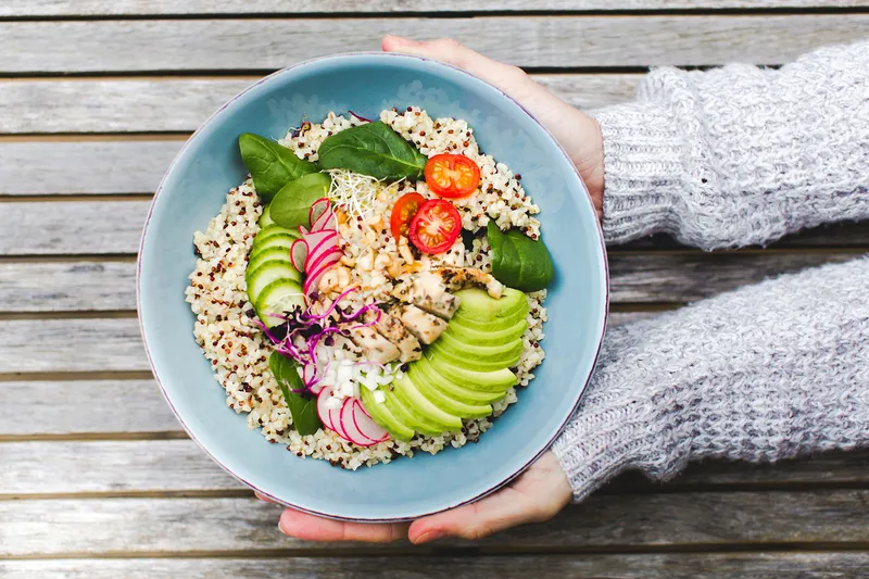 photo of cropped hands holding salad bowl