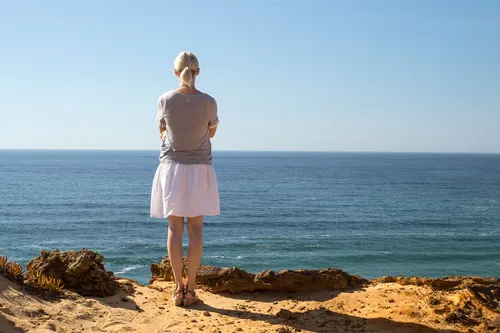photo of woman gazing at ocean