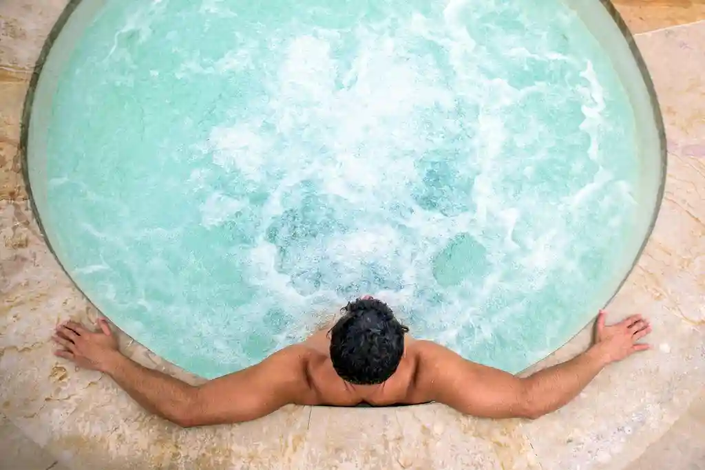 photo of man relaxing in hot tub