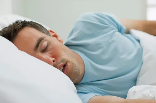 photo of sick man sleeping in bed