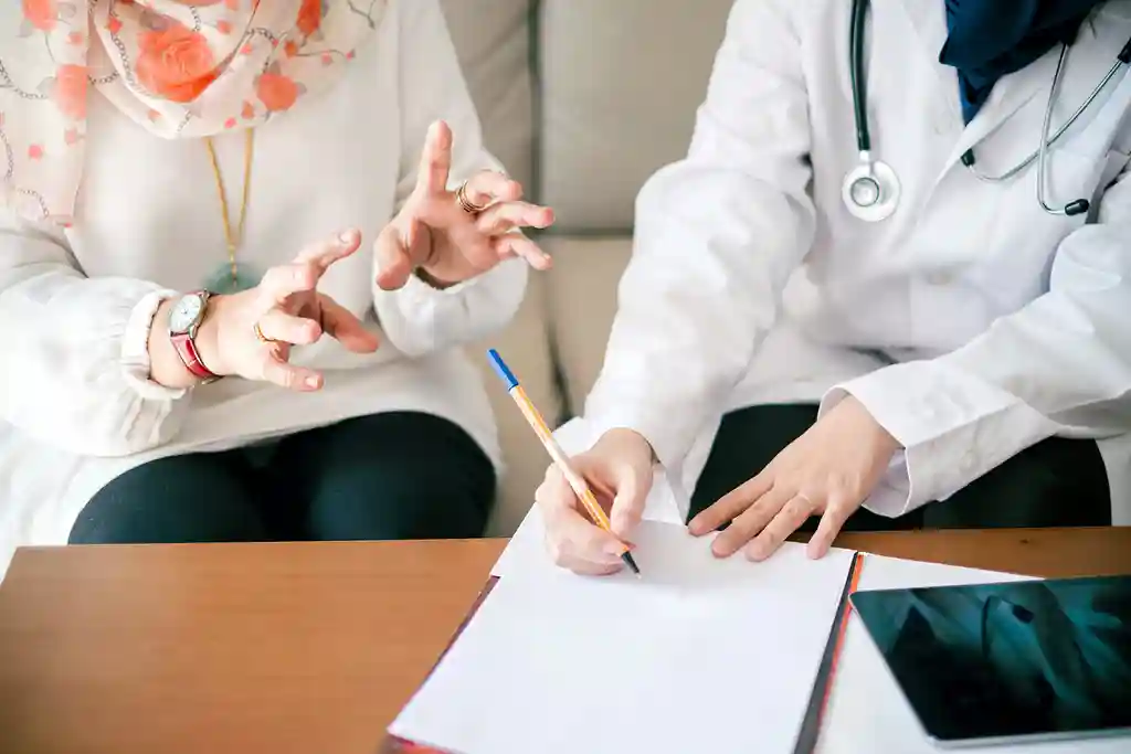 photo of doctor taking notes in patient consult