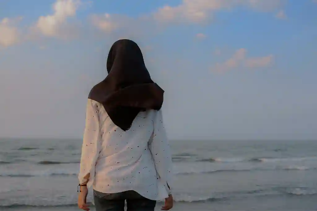 photo of woman wearing hijab looking at sea