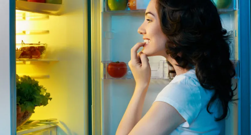 woman looking in refrigerator