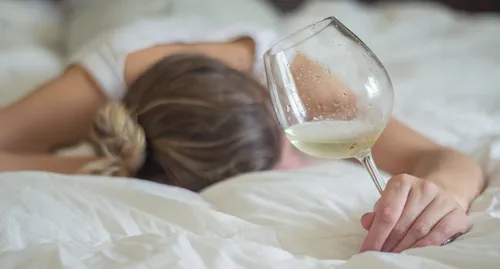 woman in bed with wine glass
