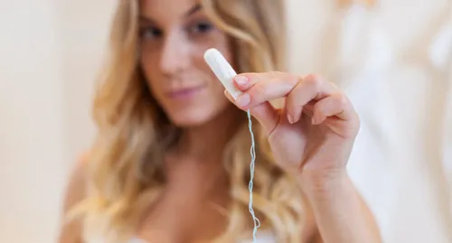 Woman holding tampon
