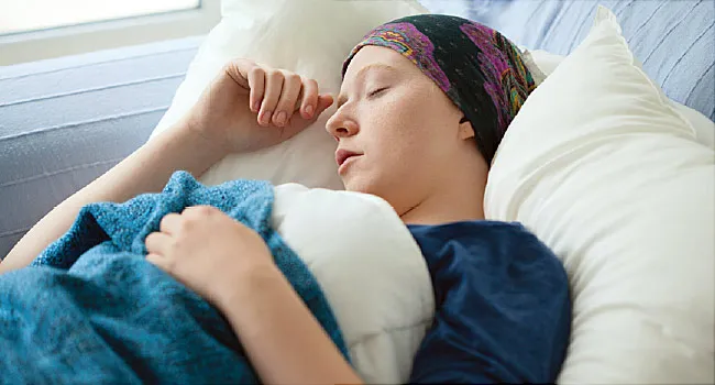 woman with cancer resting in bed