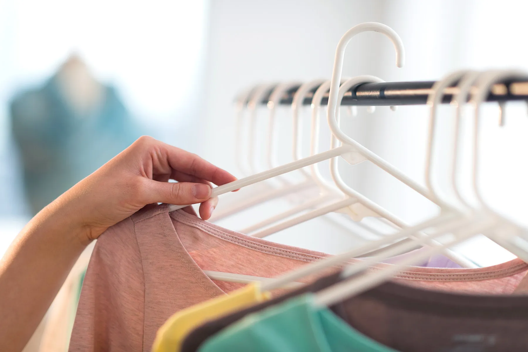 photo of woman looking at clothes