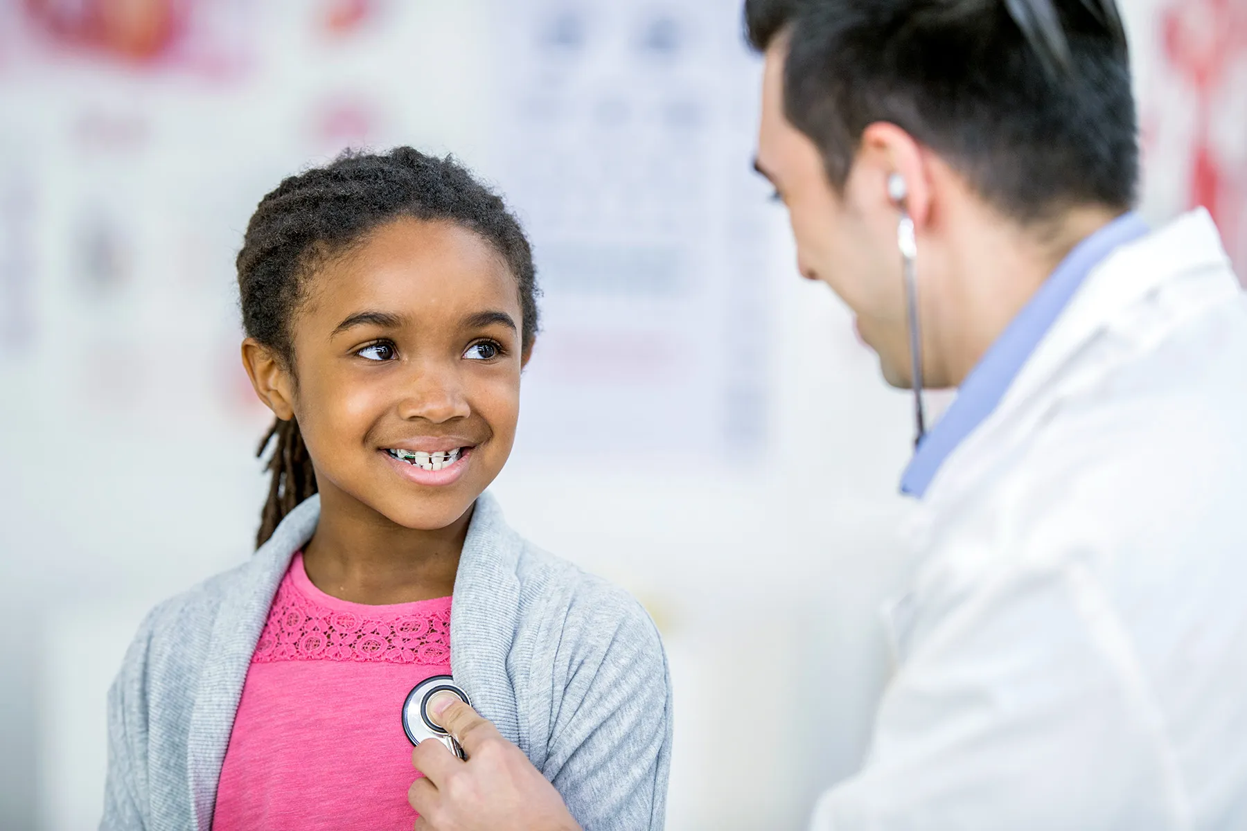 photo of pediatrician examining young girl