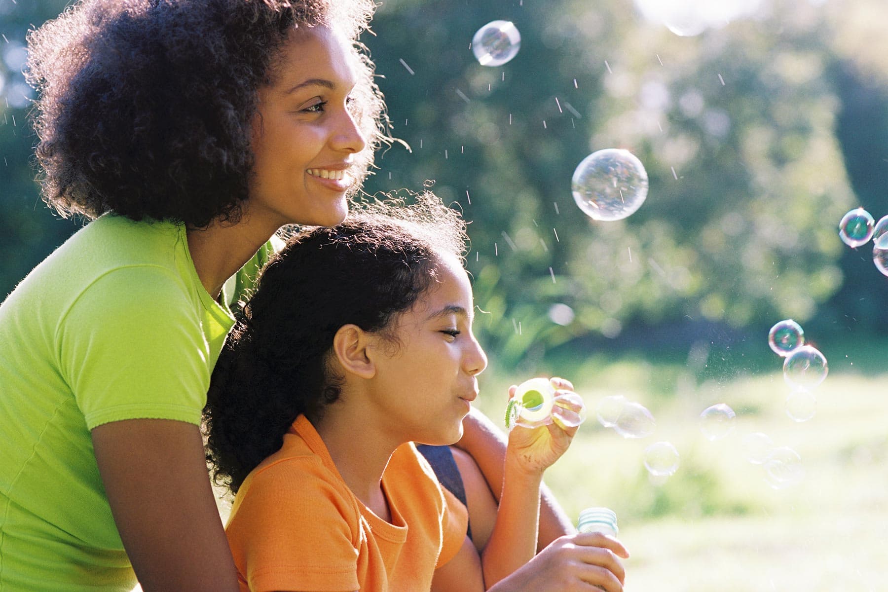 mom and daughter blowing bubbles