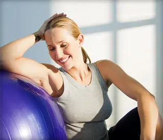 woman relaxing with exercise ball