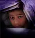 boy hiding under blanket
