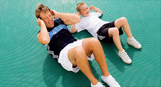 man and boy doing crunches