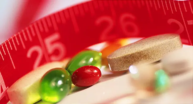 vitamins and measuring tape