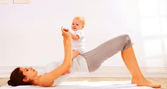 mother doing hip rolls with baby on lap