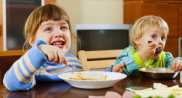 Happy children eating food