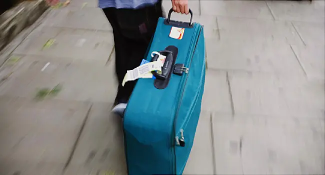 person pulling suitcase