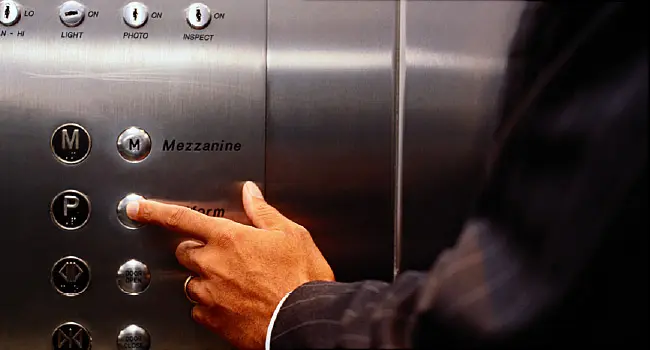 man pushing elevator button