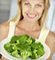 Woman holding plate of brocolli