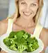 Woman holding plate of brocolli