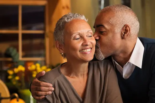 photo of senior man kissing wife