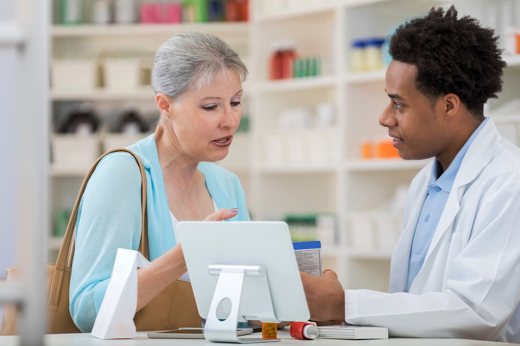 photo of senior woman talking with pharmacist
