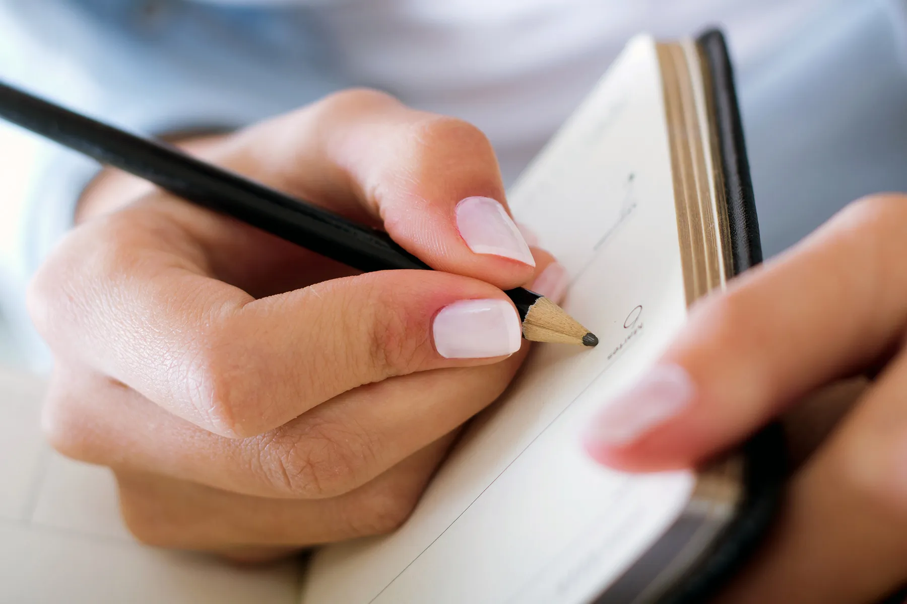 photo of a person writing in a journal