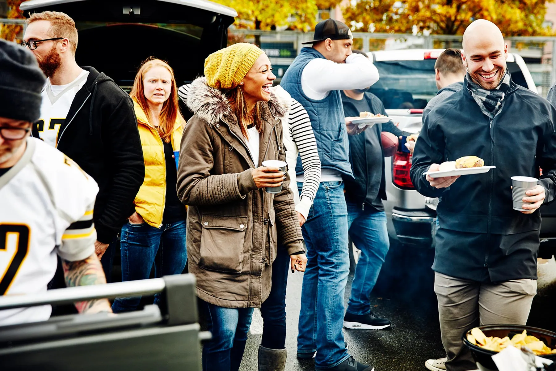 photo of friends tailgating successful  stadium parking lot