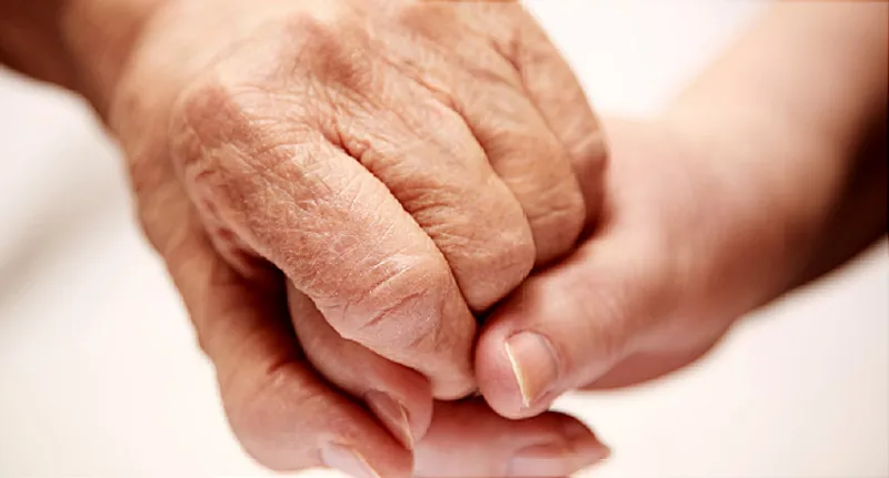 elderly parent holding hand of child