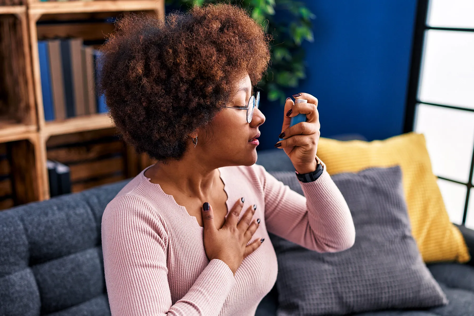 photo of woman using an asthma inhaler