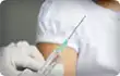 nurse holding syringe in front of girl