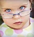 little girl wearing glasses
