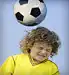 boy hits soccer ball with head